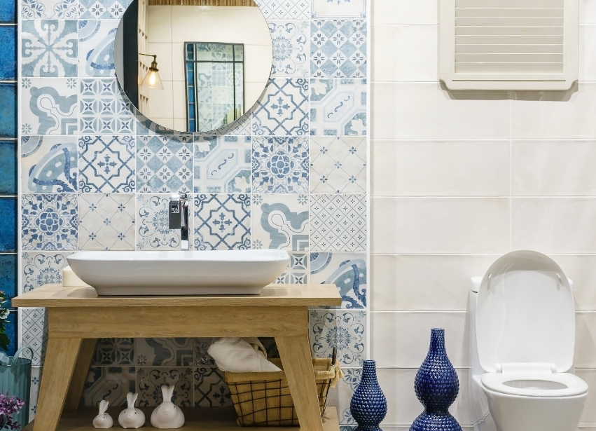 Bathroom with patterned blue and white tiles and timber vanity