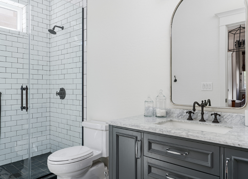 Grey vanity and shower in a bright bathroom